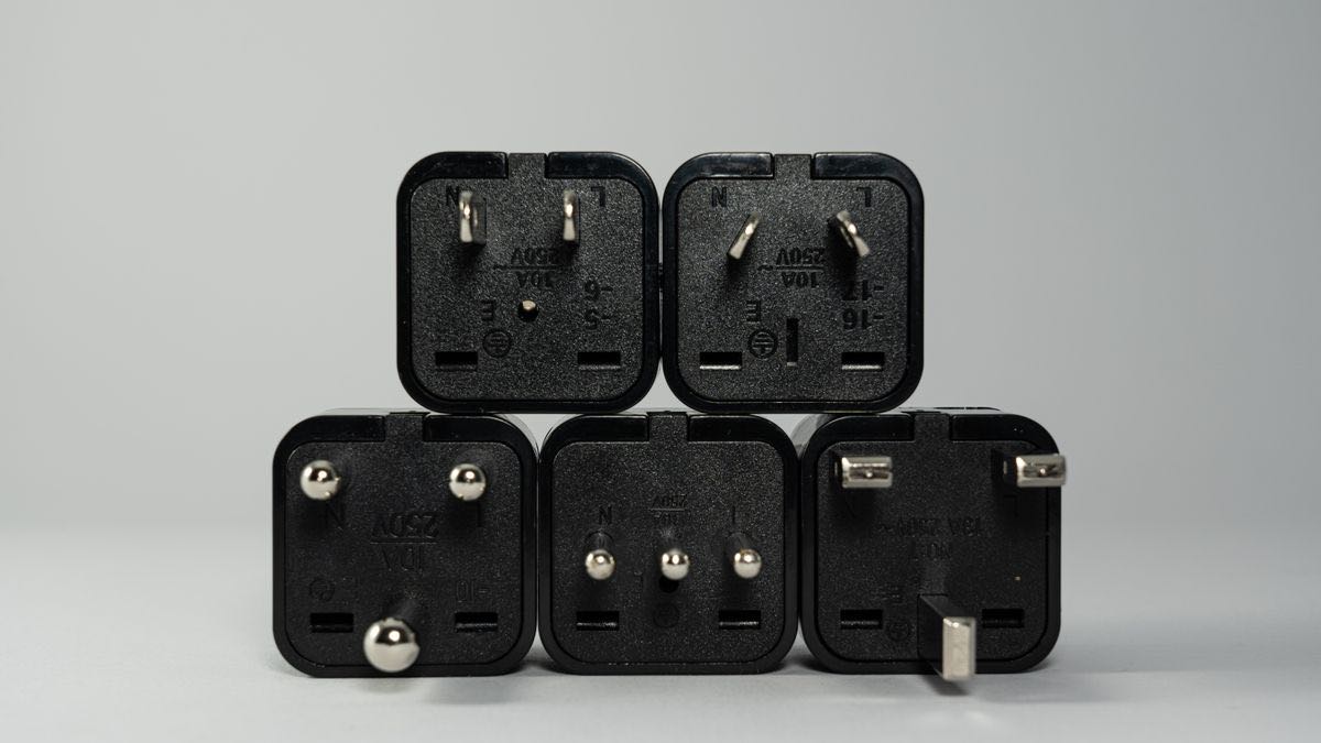 Five international power plug adapters stacked together — one search tool that fits any AI model