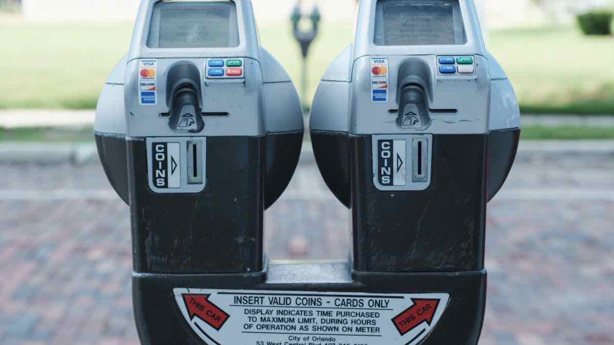 Two twin parking meters photographed head-on, the plate beneath them reading INSERT VALID COINS and CARDS ONLY
