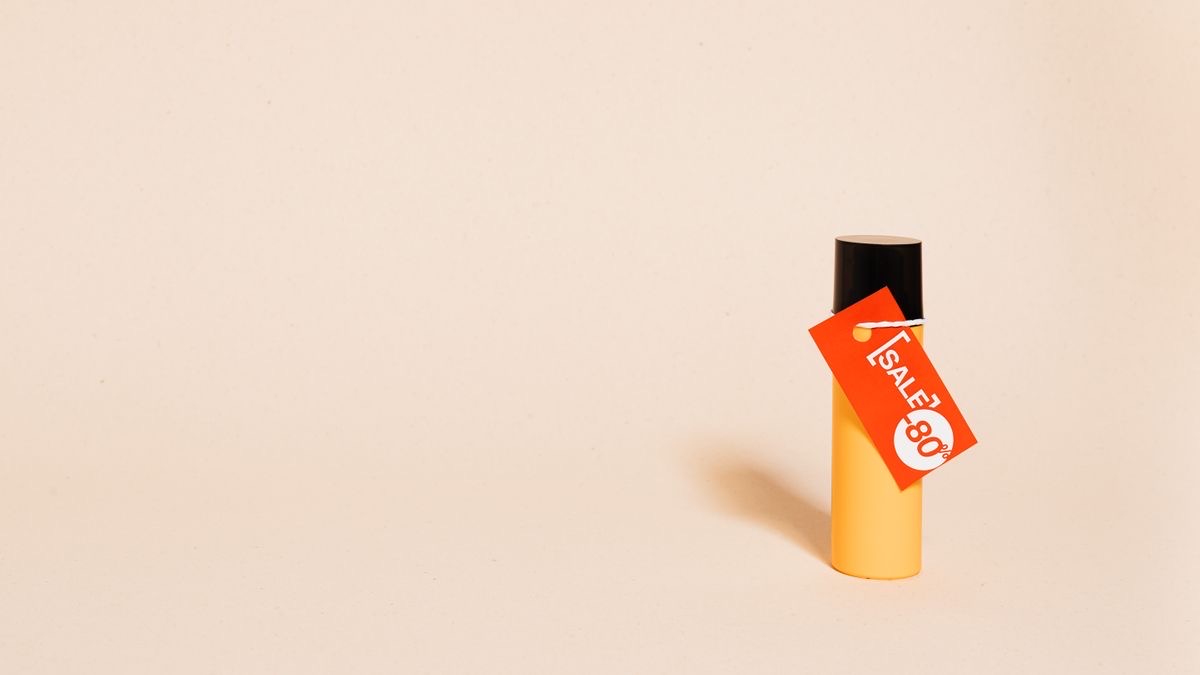 A bold red SALE 80% tag hanging off a plain bottle, the discount label at the centre of Bright Data LinkedIn pricing