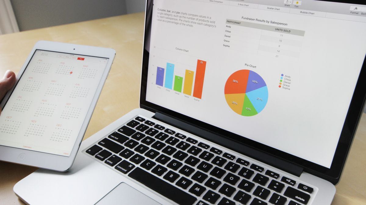 A laptop showing a data table beside a tablet with a chart, the shape you read from the response