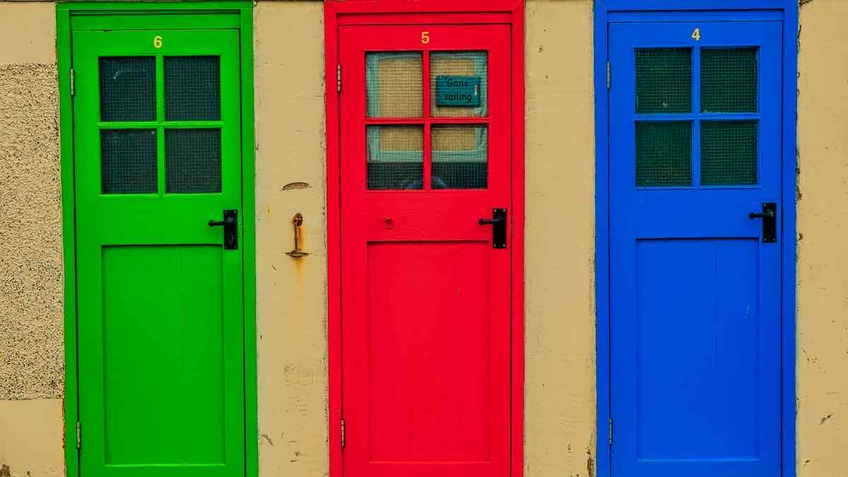Three numbered doors in different colors, representing DataForSEO's three pricing queues