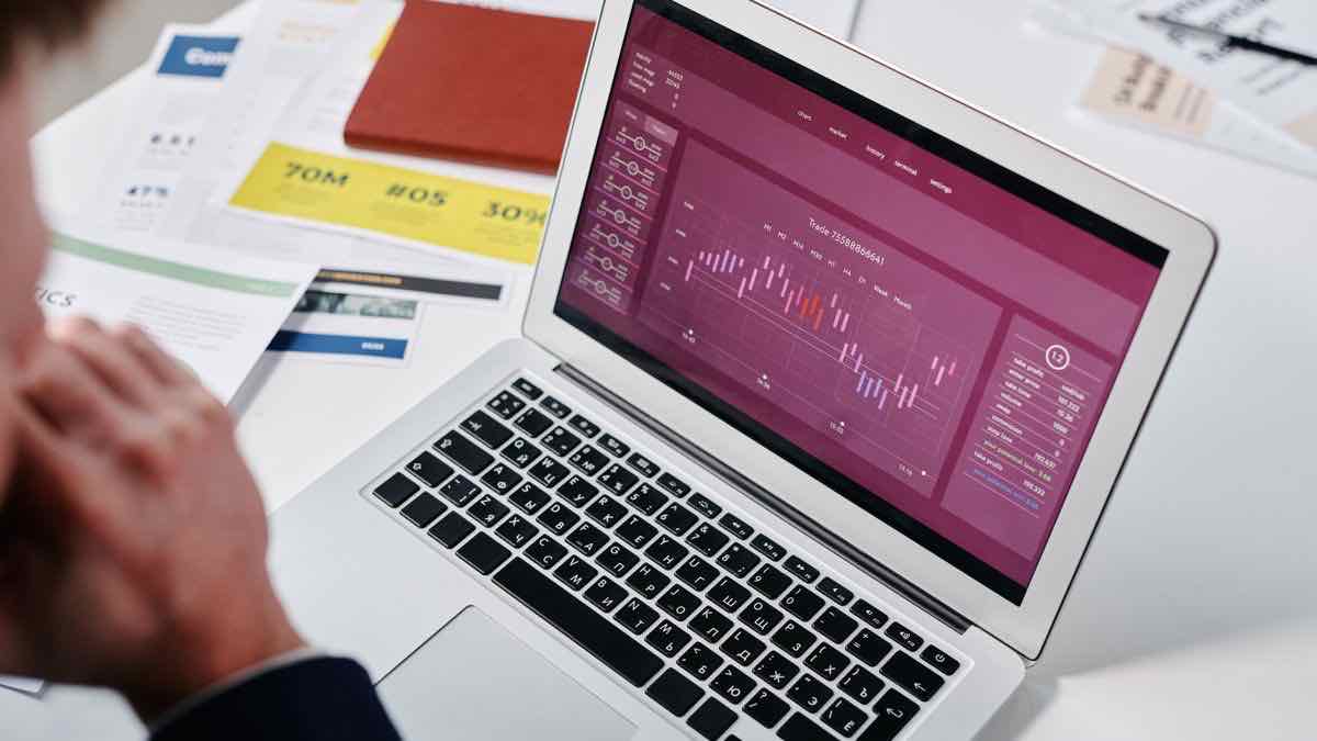 A person analyzing charts and graphs on a screen, representing market intelligence work
