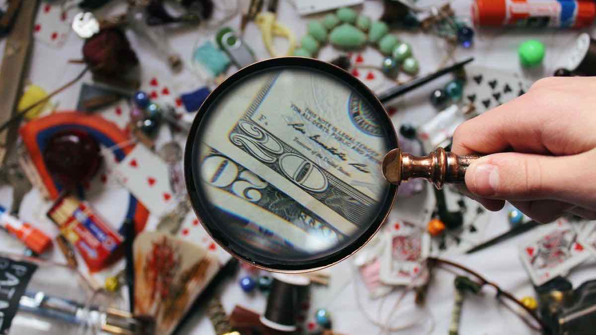 A magnifying glass over a dollar bill, representing a close look at SerpApi pricing