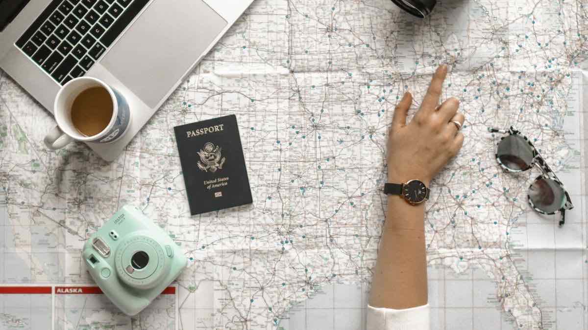 A finger pointing at one location on a paper map of the United States, representing UULE location encoding