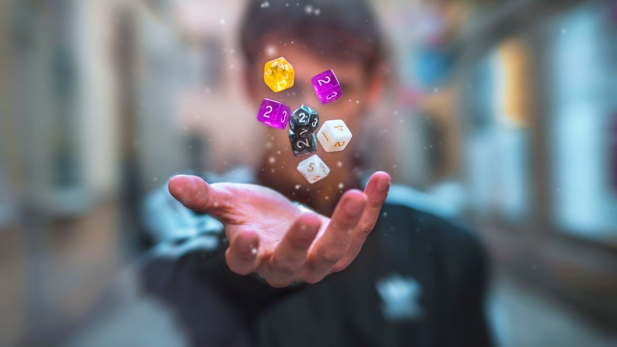 A hand tossing colorful dice, representing Google search results changing on every roll